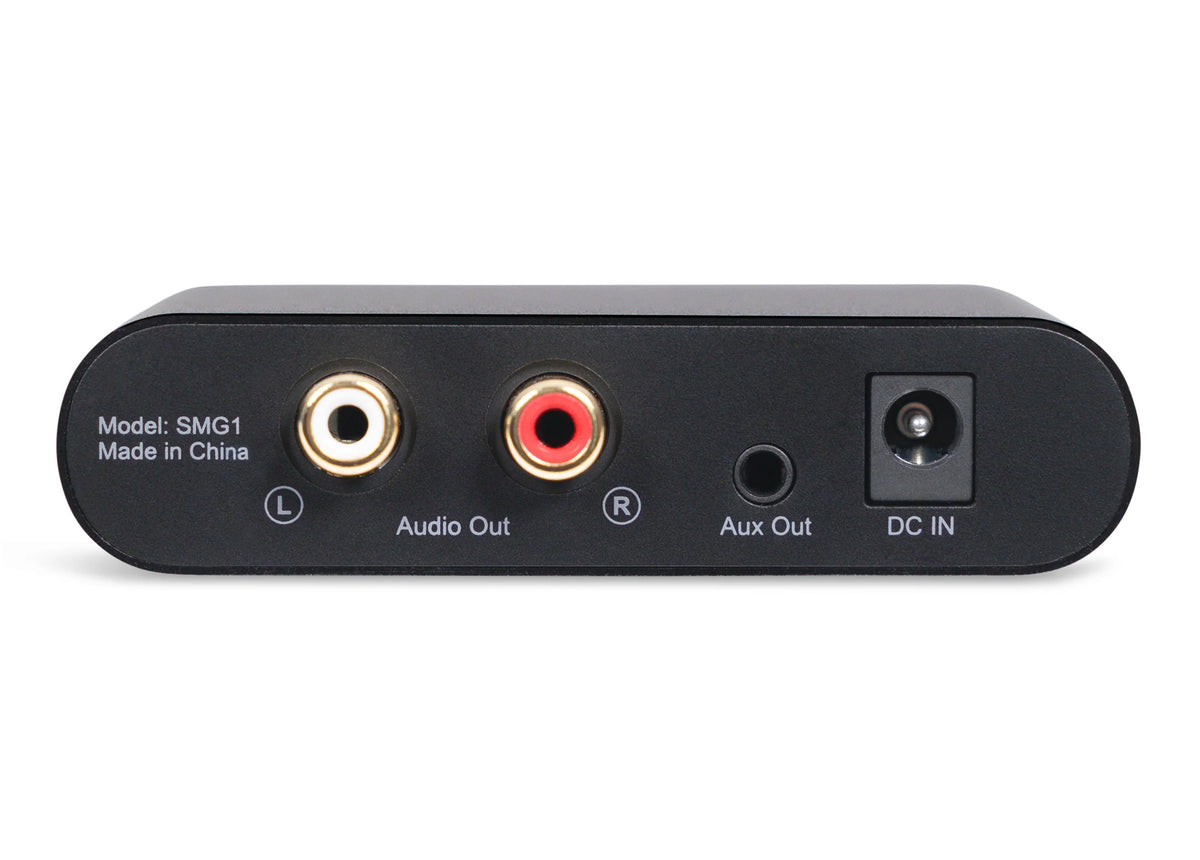 Black sound masking generator with audio and aux outputs, labeled ports, and a DC input. Model SMG1.